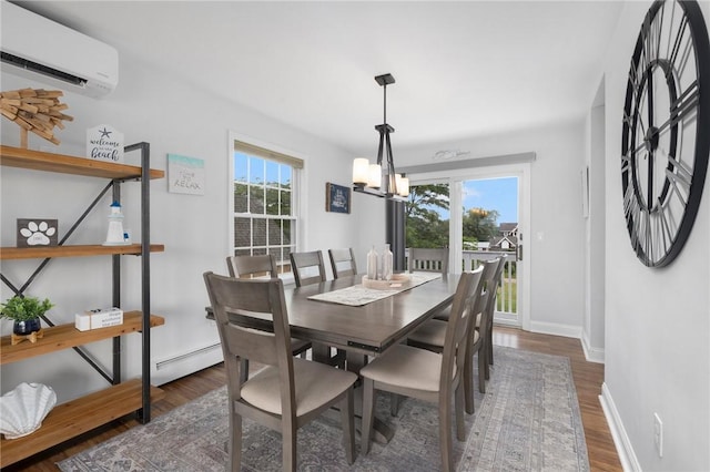 dining space featuring a baseboard radiator, dark wood-type flooring, a wall unit AC, and a chandelier