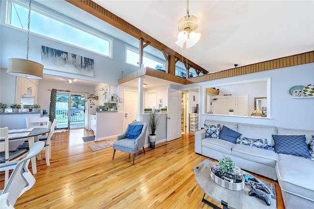 living room featuring light hardwood / wood-style flooring and a towering ceiling