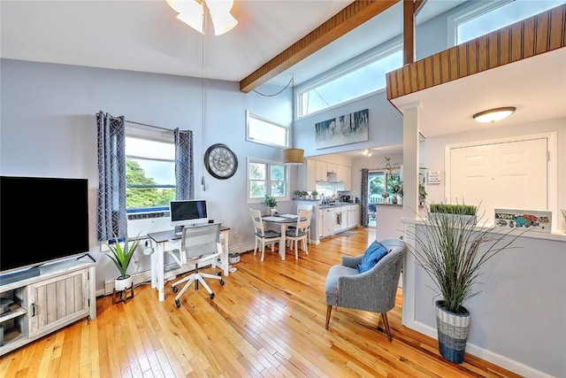 office featuring a high ceiling and light hardwood / wood-style floors