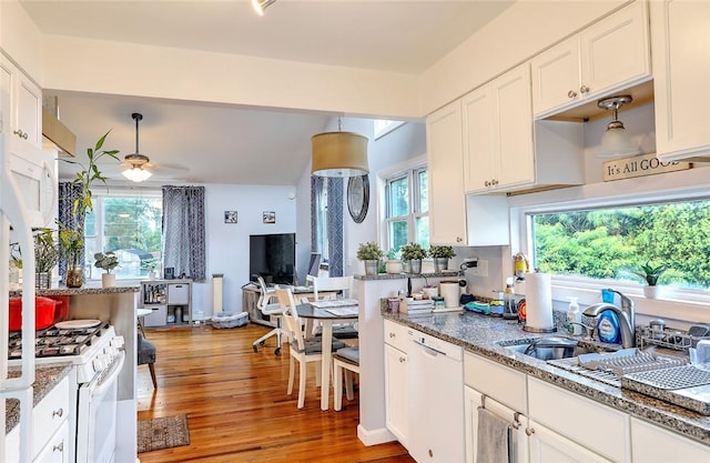 kitchen featuring white appliances, ceiling fan, and white cabinetry