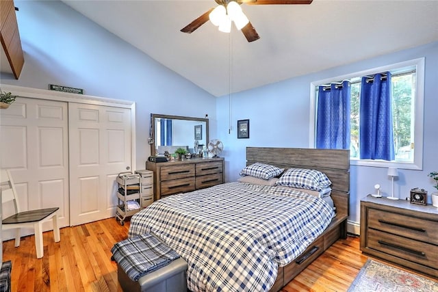 bedroom featuring vaulted ceiling, ceiling fan, light hardwood / wood-style flooring, a closet, and baseboard heating