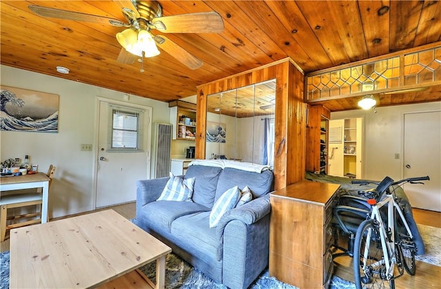 living room featuring light wood-type flooring, ceiling fan, and wooden ceiling