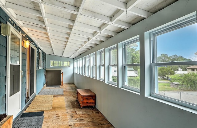 hall with dark wood-type flooring and beam ceiling