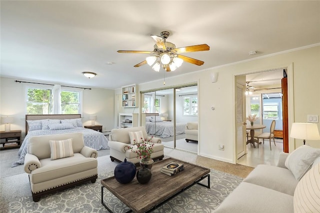 bedroom with ceiling fan and ornamental molding