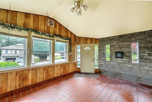 unfurnished sunroom featuring vaulted ceiling