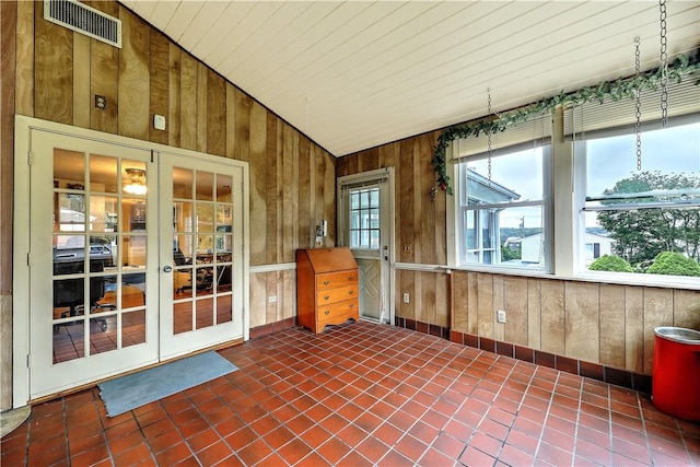 unfurnished sunroom with lofted ceiling and french doors