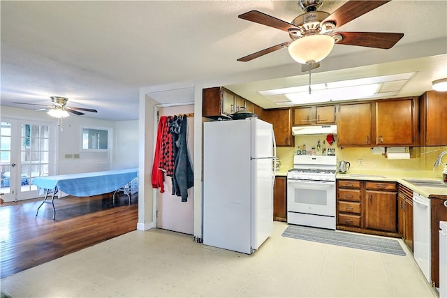 kitchen with white appliances, ceiling fan, french doors, and sink