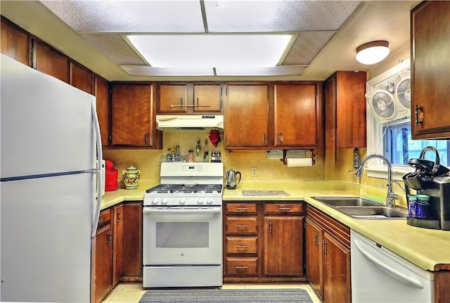 kitchen with sink, white appliances, and light tile patterned floors