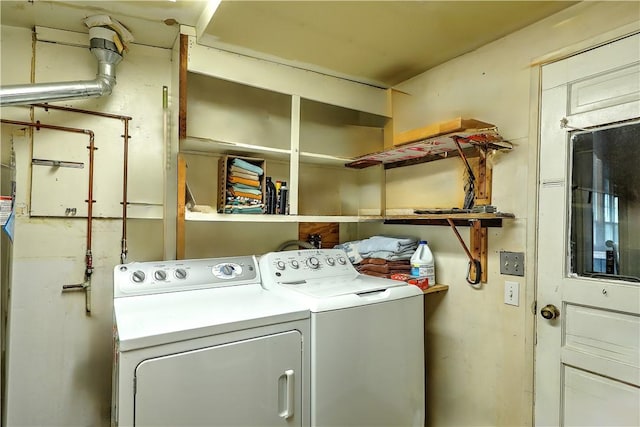 clothes washing area featuring independent washer and dryer