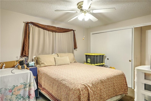 carpeted bedroom featuring a textured ceiling and ceiling fan