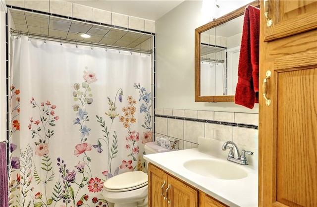 bathroom featuring tile walls, a shower with shower curtain, vanity, and toilet