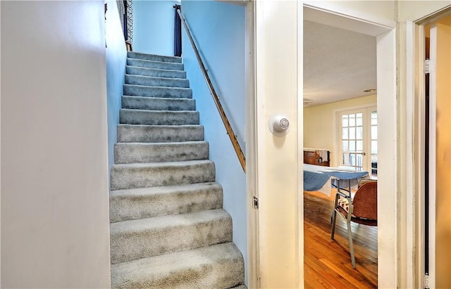 staircase featuring wood-type flooring