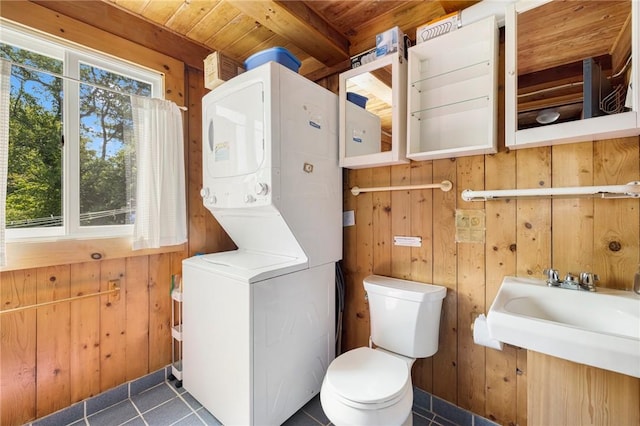 681 Corn Neck Rd, Block Island, RI 02807 - washroom featuring stacked washer / drying machine, wooden walls, wood ceiling, and tile patterned floors