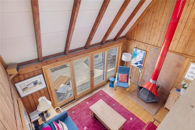 681 Corn Neck Rd, Block Island, RI 02807 - living area featuring wood walls, a wood stove, and hardwood / wood-style floors