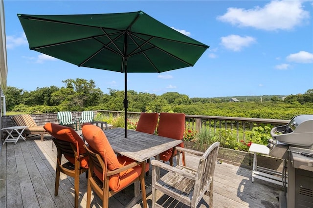681 Corn Neck Rd, Block Island, RI 02807 - deck with outdoor dining area, a grill, and a wooded view