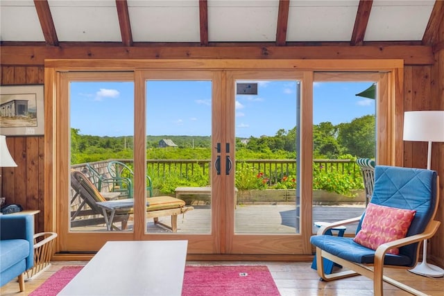 681 Corn Neck Rd, Block Island, RI 02807 - doorway featuring wood walls, beam ceiling, and light wood finished floors