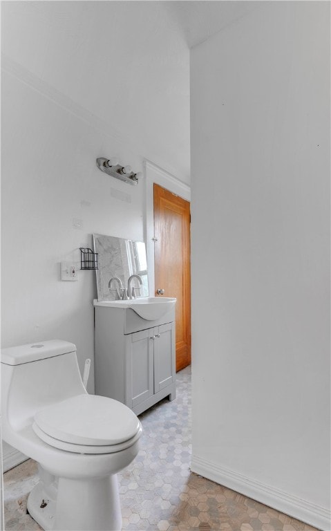 bathroom with vanity, tile patterned flooring, and toilet