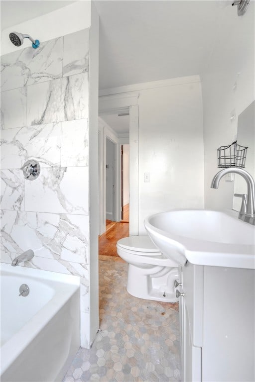 full bathroom featuring wood-type flooring, vanity, toilet, and tiled shower / bath