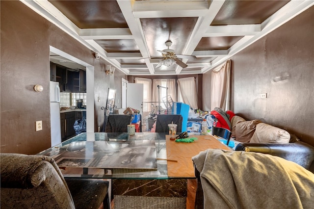 living room featuring beamed ceiling, coffered ceiling, and ceiling fan