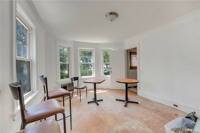 living area with light hardwood / wood-style flooring and ornamental molding