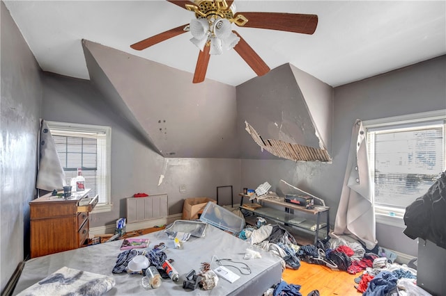 bedroom featuring ceiling fan, lofted ceiling, and hardwood / wood-style flooring