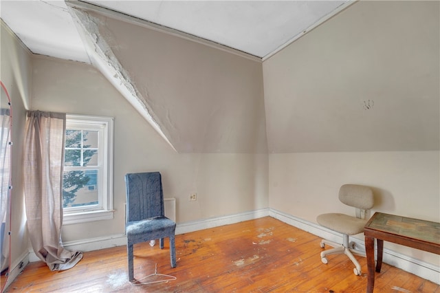 sitting room featuring lofted ceiling, hardwood / wood-style floors, and crown molding