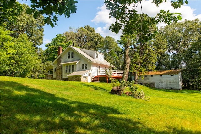 back of property with a lawn and a wooden deck