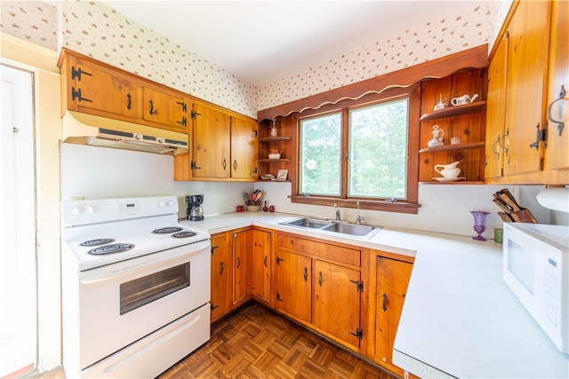 kitchen with sink, dark parquet flooring, and white appliances