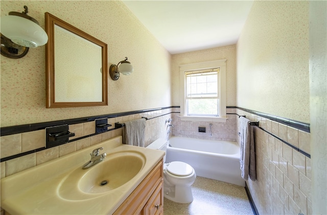 bathroom with tasteful backsplash, a bathtub, toilet, vanity, and tile walls