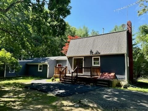 back of property with a wooden deck