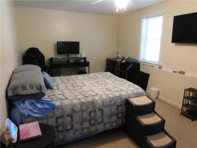 bedroom featuring ceiling fan and carpet