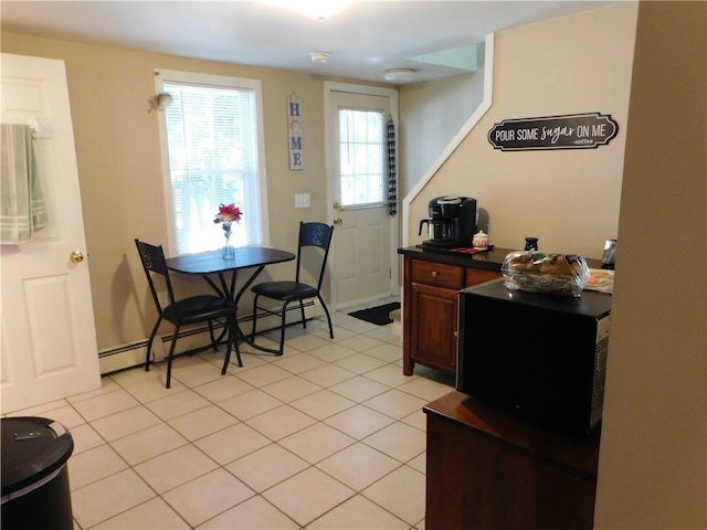 tiled dining space with baseboard heating