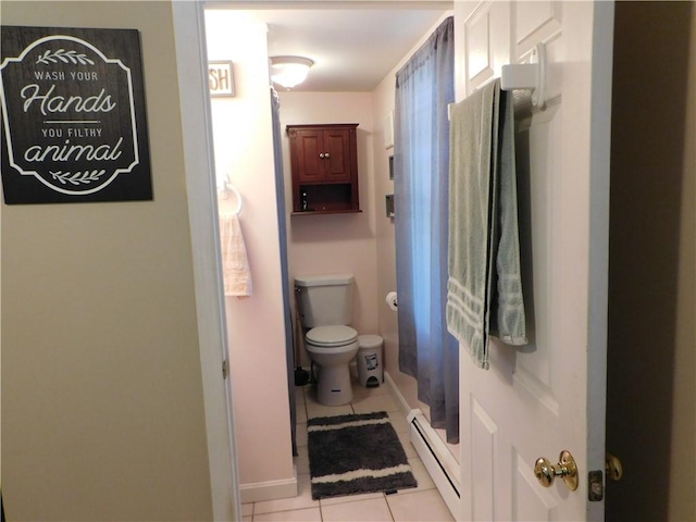 bathroom with a baseboard heating unit, toilet, and tile patterned flooring