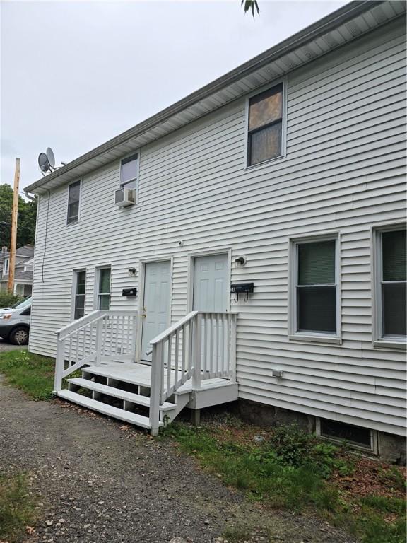 rear view of house with cooling unit