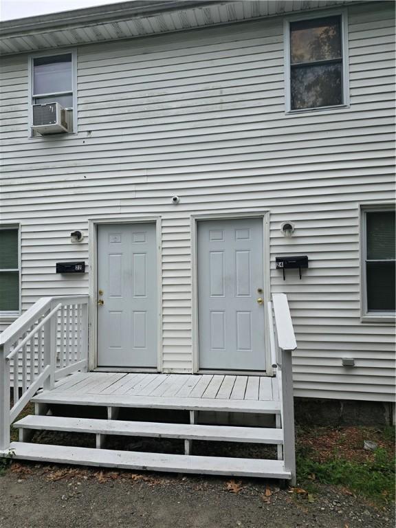 doorway to property featuring cooling unit