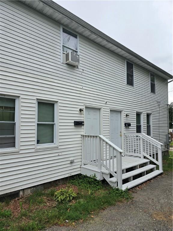 rear view of house featuring cooling unit