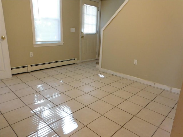 foyer featuring baseboard heating and light tile patterned floors