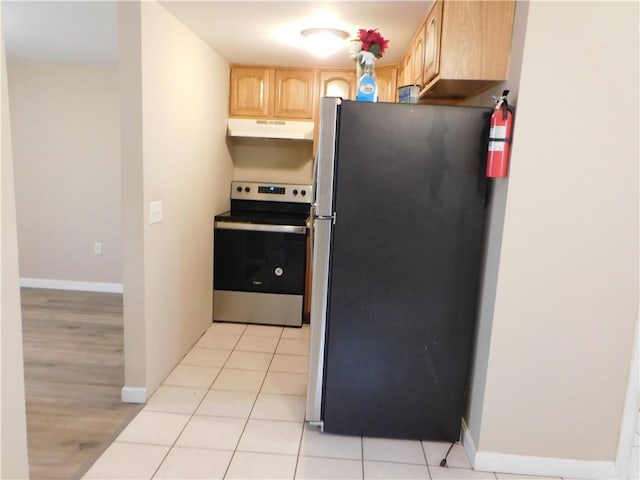 kitchen featuring light tile patterned floors, light brown cabinetry, and stainless steel appliances