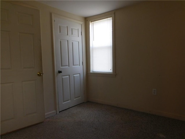 carpeted empty room featuring a healthy amount of sunlight