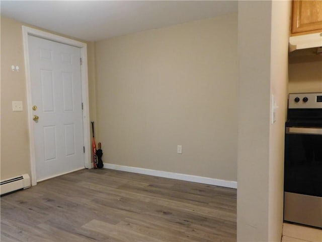 spare room featuring light hardwood / wood-style floors and a baseboard radiator