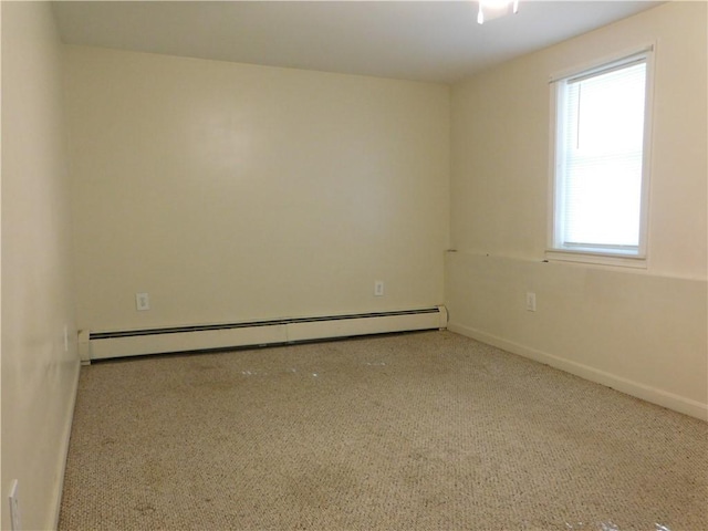 spare room with light colored carpet and a baseboard radiator