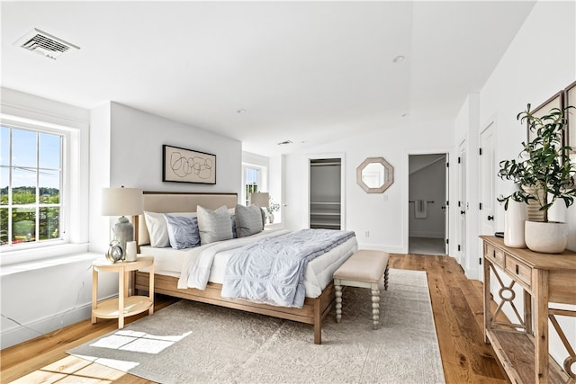 bedroom with wood-type flooring and vaulted ceiling