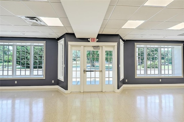 interior space with a paneled ceiling