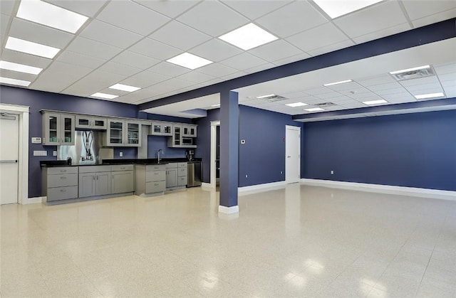 kitchen with gray cabinets, sink, dishwasher, and a drop ceiling