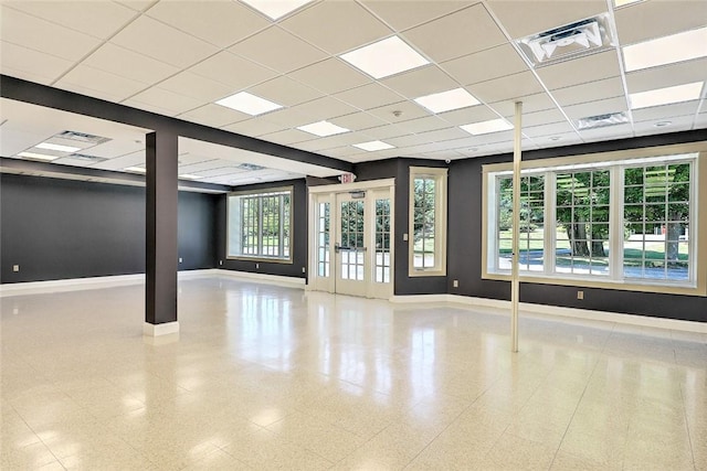 interior space featuring french doors, a paneled ceiling, and a wealth of natural light