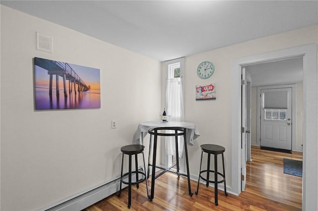 interior space featuring a baseboard radiator and hardwood / wood-style floors