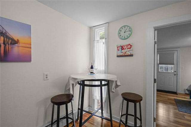 dining space with dark hardwood / wood-style floors