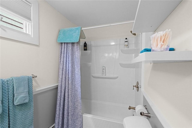 bathroom with shower / tub combo and toilet