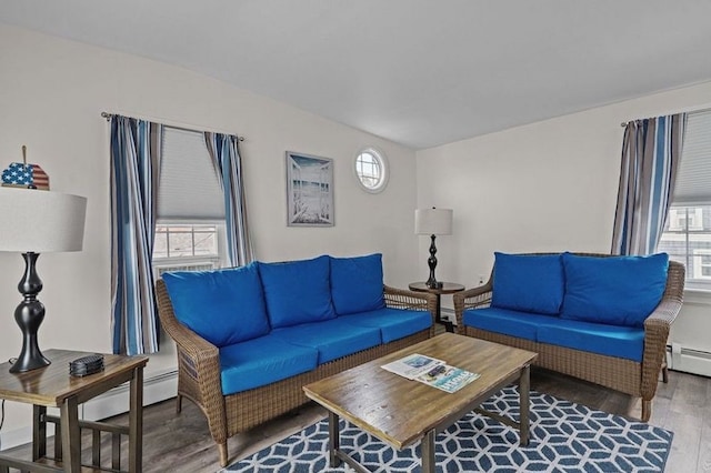 living room featuring hardwood / wood-style flooring, baseboard heating, and a wealth of natural light