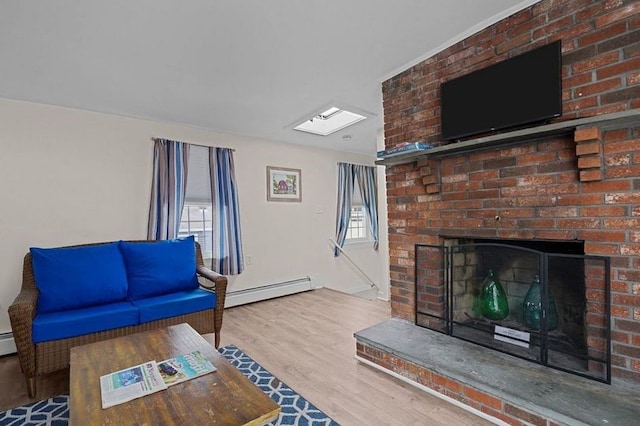 living room with a baseboard radiator, wood-type flooring, and a brick fireplace